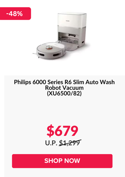 Woman wearing an olive green blazer and light blue jeans walking in an urban setting.