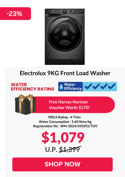 Woman wearing an olive green blazer and light blue jeans walking in an urban setting.