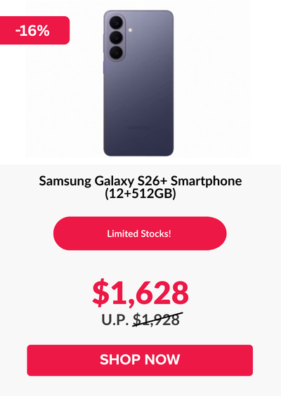 Man in a gray blazer over a dark gray shirt standing on stairs in an urban background.