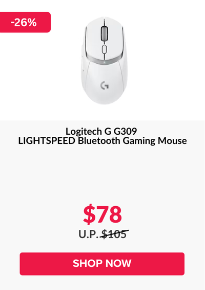 Woman wearing an olive green blazer and light blue jeans walking in an urban setting.