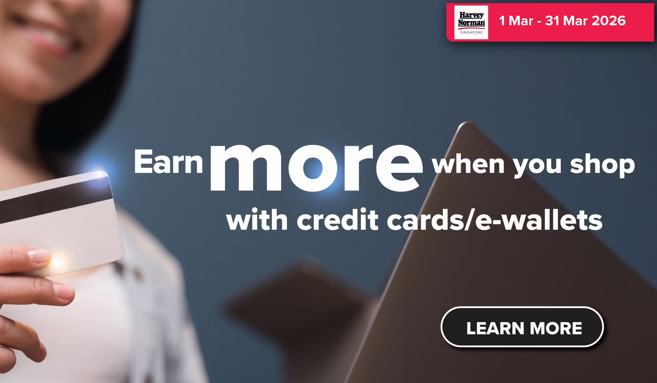 Woman wearing an olive green blazer and light blue jeans walking in an urban setting.