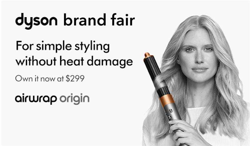 Three women enjoying a shopping day, carrying multiple colorful shopping bags while walking together outdoors.