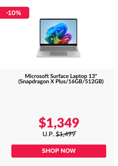 Man in a gray blazer over a dark gray shirt standing on stairs in an urban background.