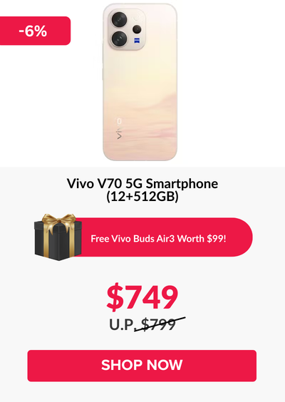 Man in a gray blazer over a dark gray shirt standing on stairs in an urban background.