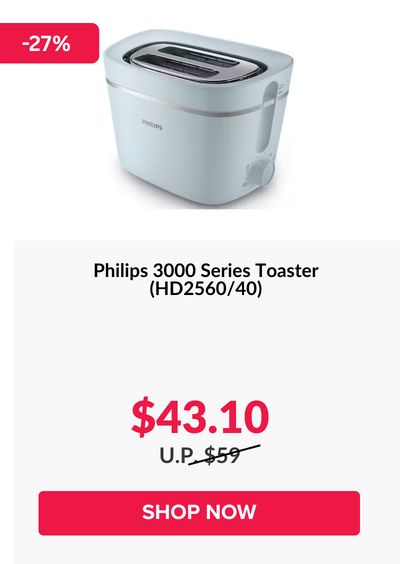 Woman wearing an olive green blazer and light blue jeans walking in an urban setting.