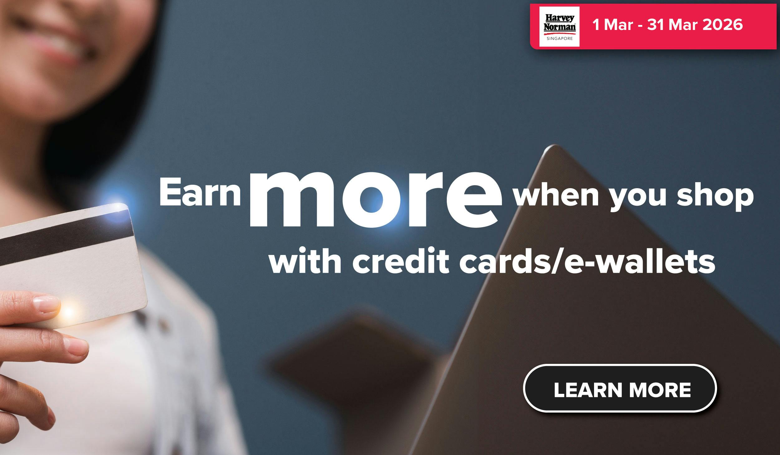 Woman wearing an olive green blazer and light blue jeans walking in an urban setting.