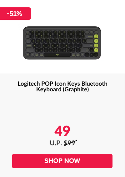 Woman wearing an olive green blazer and light blue jeans walking in an urban setting.