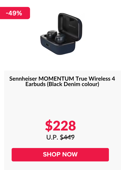 Woman wearing an olive green blazer and light blue jeans walking in an urban setting.