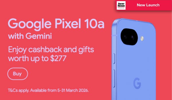 Man in a gray blazer over a dark gray shirt standing on stairs in an urban background.