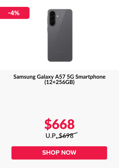 Man in a gray blazer over a dark gray shirt standing on stairs in an urban background.