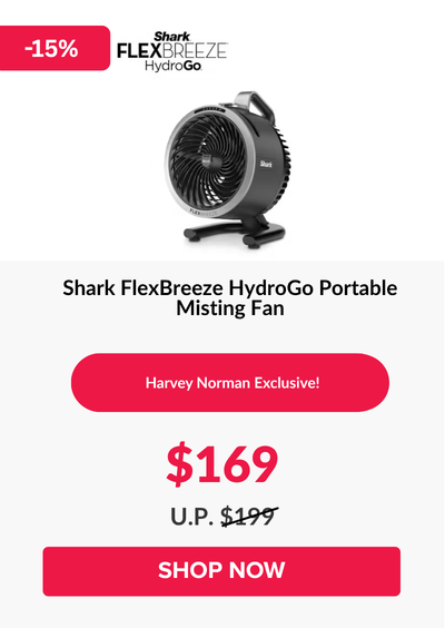 Man in a gray blazer over a dark gray shirt standing on stairs in an urban background.