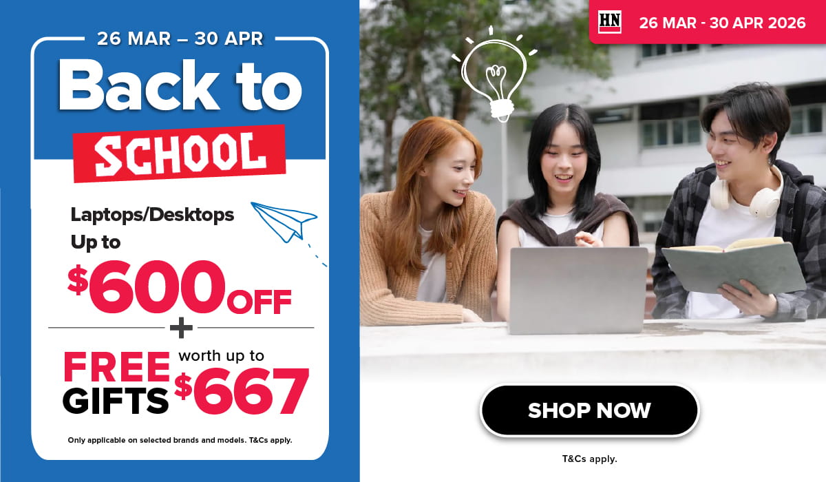 Man in a gray blazer over a dark gray shirt standing on stairs in an urban background.