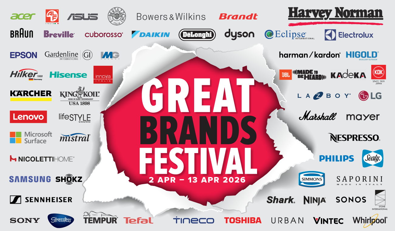 Three women enjoying a shopping day, carrying multiple colorful shopping bags while walking together outdoors.