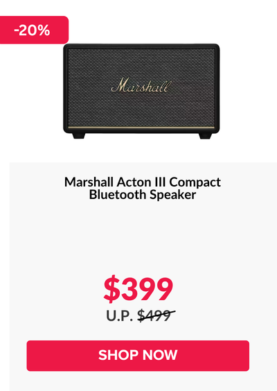 Woman wearing an olive green blazer and light blue jeans walking in an urban setting.