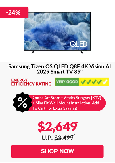 Man in a gray blazer over a dark gray shirt standing on stairs in an urban background.