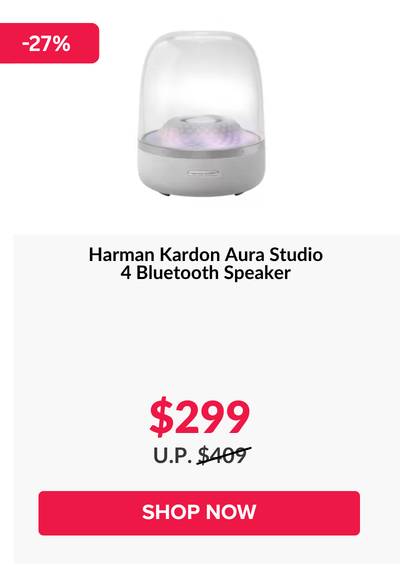 Woman wearing an olive green blazer and light blue jeans walking in an urban setting.