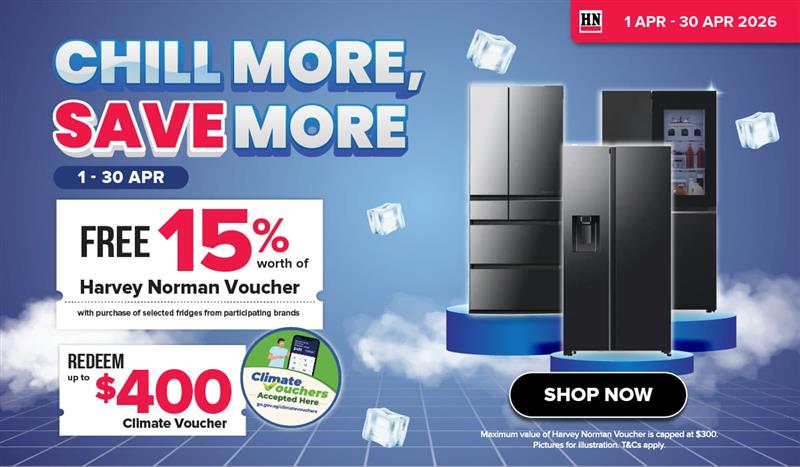 Woman wearing an olive green blazer and light blue jeans walking in an urban setting.