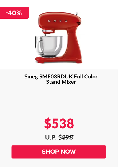 Man in a gray blazer over a dark gray shirt standing on stairs in an urban background.