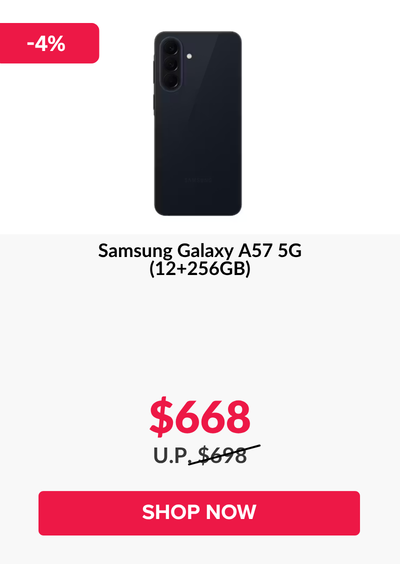 Man in a gray blazer over a dark gray shirt standing on stairs in an urban background.