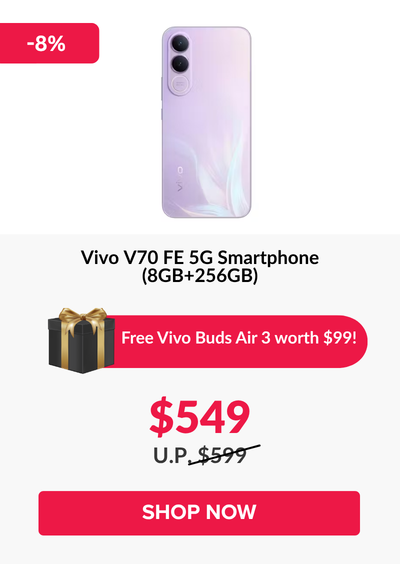 Man in a gray blazer over a dark gray shirt standing on stairs in an urban background.