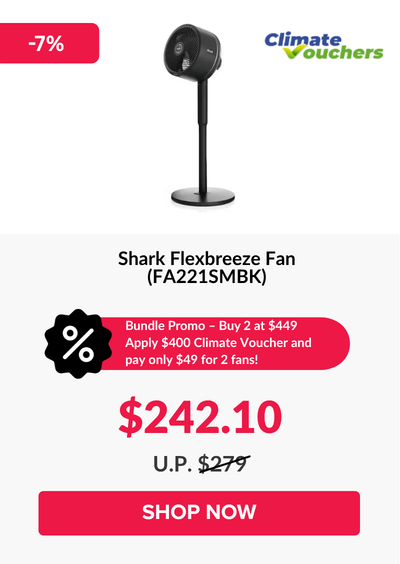 Man in a gray blazer over a dark gray shirt standing on stairs in an urban background.