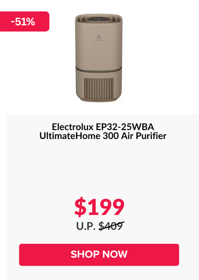 Woman wearing an olive green blazer and light blue jeans walking in an urban setting.