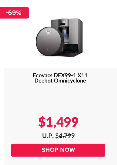 Woman wearing an olive green blazer and light blue jeans walking in an urban setting.