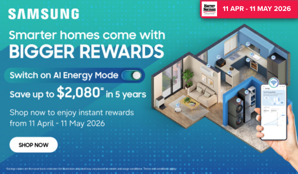 Woman wearing an olive green blazer and light blue jeans walking in an urban setting.