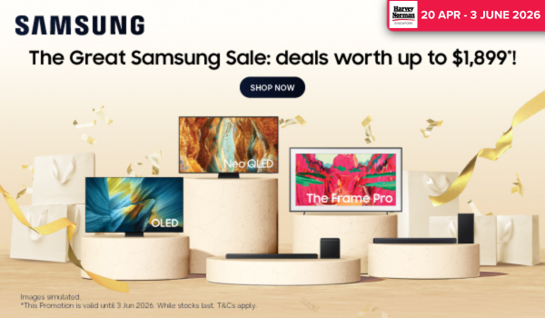 Man in a gray blazer over a dark gray shirt standing on stairs in an urban background.