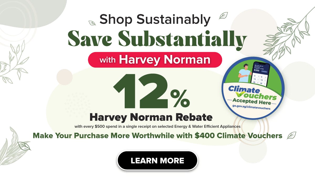 Woman wearing an olive green blazer and light blue jeans walking in an urban setting.