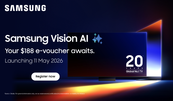 Woman wearing an olive green blazer and light blue jeans walking in an urban setting.