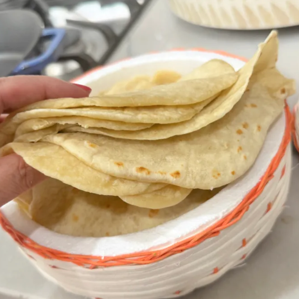 A warm, homemade tortilla with butter— SO GOOD!