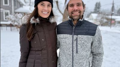 man and woman posing together in outerwear