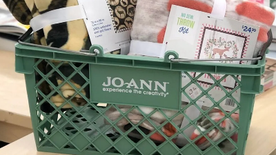 Joann cart on a coutnertop filled with craft items, plankets, yarn and more