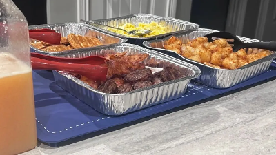  Blue Food Warming Mat with trays of food sitting on top