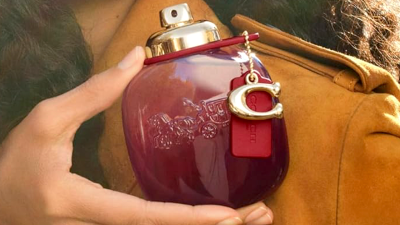 hand holding Coach perfume