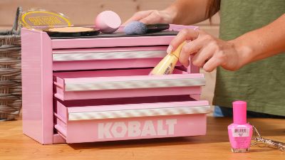 woman pulling a bottle of foundation from a pink kobalt toolbox