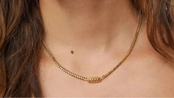 woman wearing gold necklace