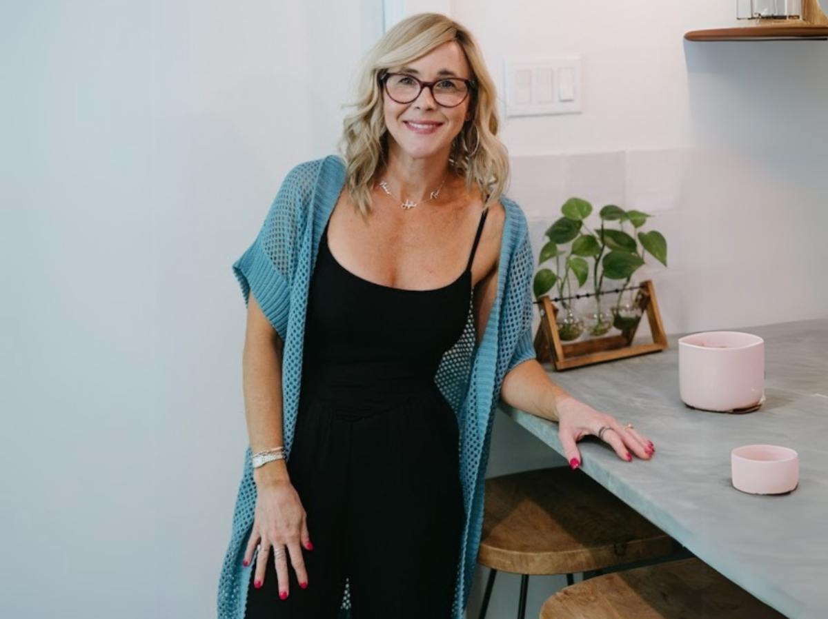 Collin wearing an aqua-blue crochet duster over a black tank top