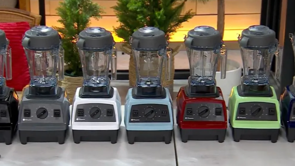 lineup of vitamix blenders in a row in white, green, red, and more