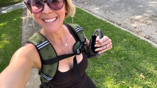 smiling woman wearing a weighted walking vest