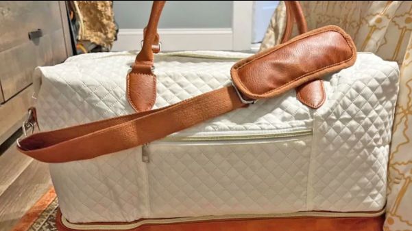 brown and cream colored weekender travel bag