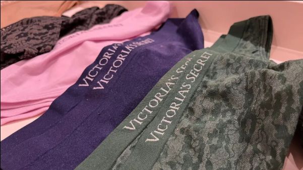 various pairs of Victoria's Secret underwear displayed on a table