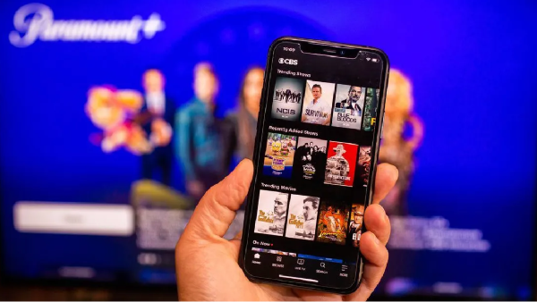 phone with paramount plus app open in front of a television