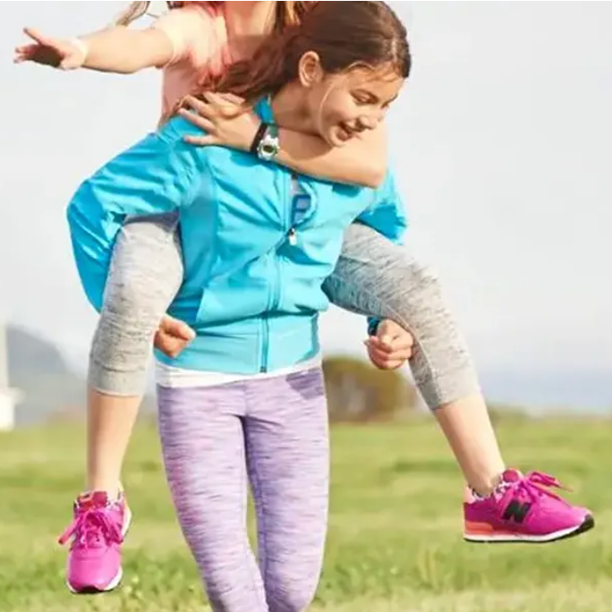 a woman carrying a child on her back in a field