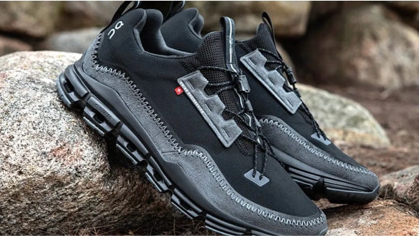 Black On running shoes sat on top of a rock