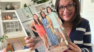 woman holding up canvas print