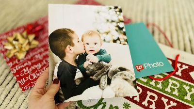 hand holding photo of kids 