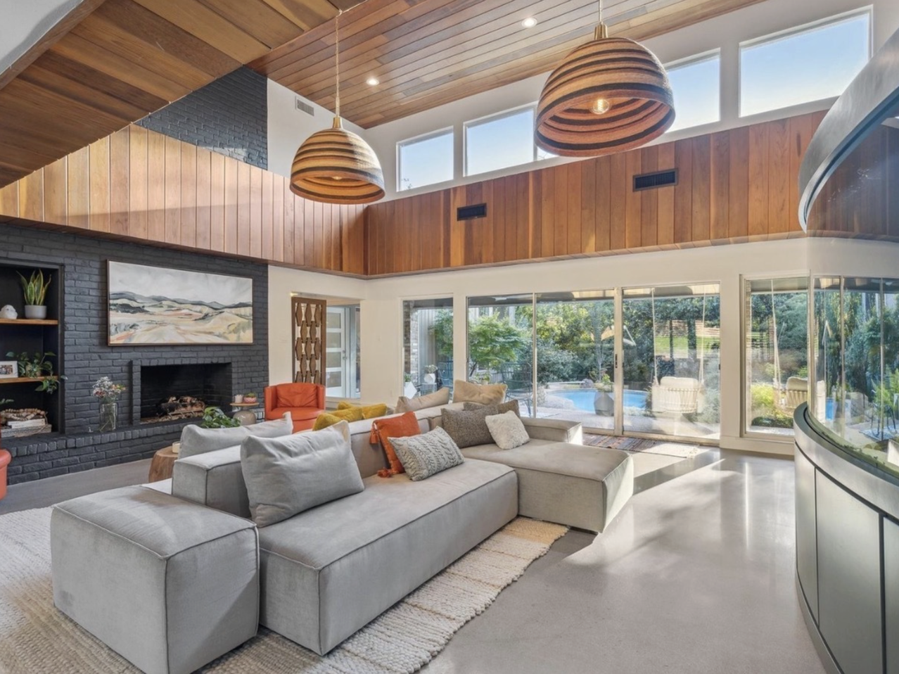 a woman wearing glasses and a black tank top with her hand out and a finger