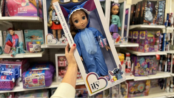 a person holding up a doll in a box